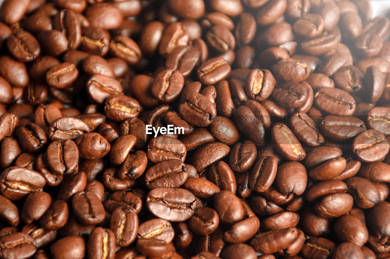 FULL FRAME SHOT OF COFFEE BEANS IN BACKGROUND