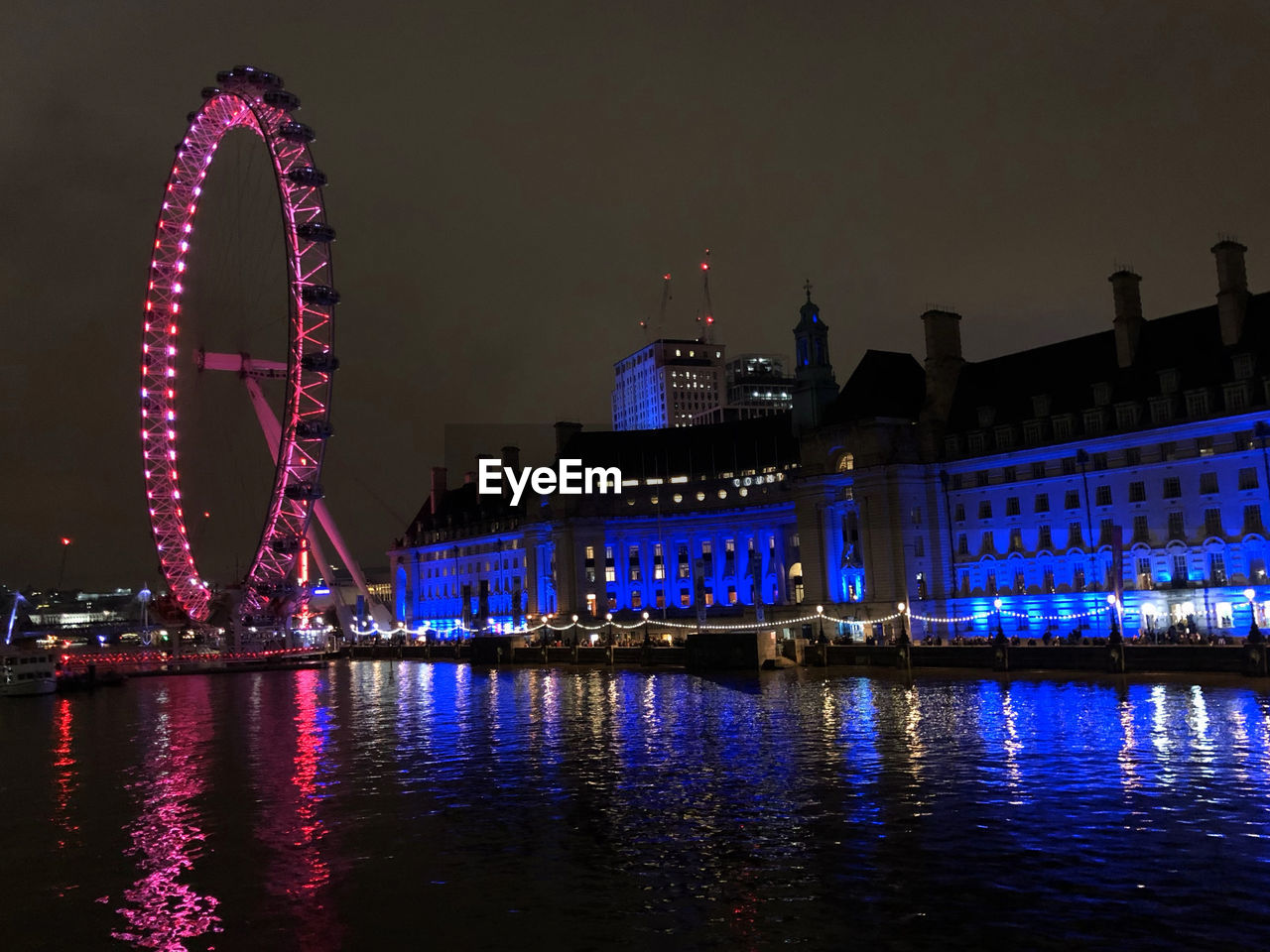 London eye by night lightening in pink and blue