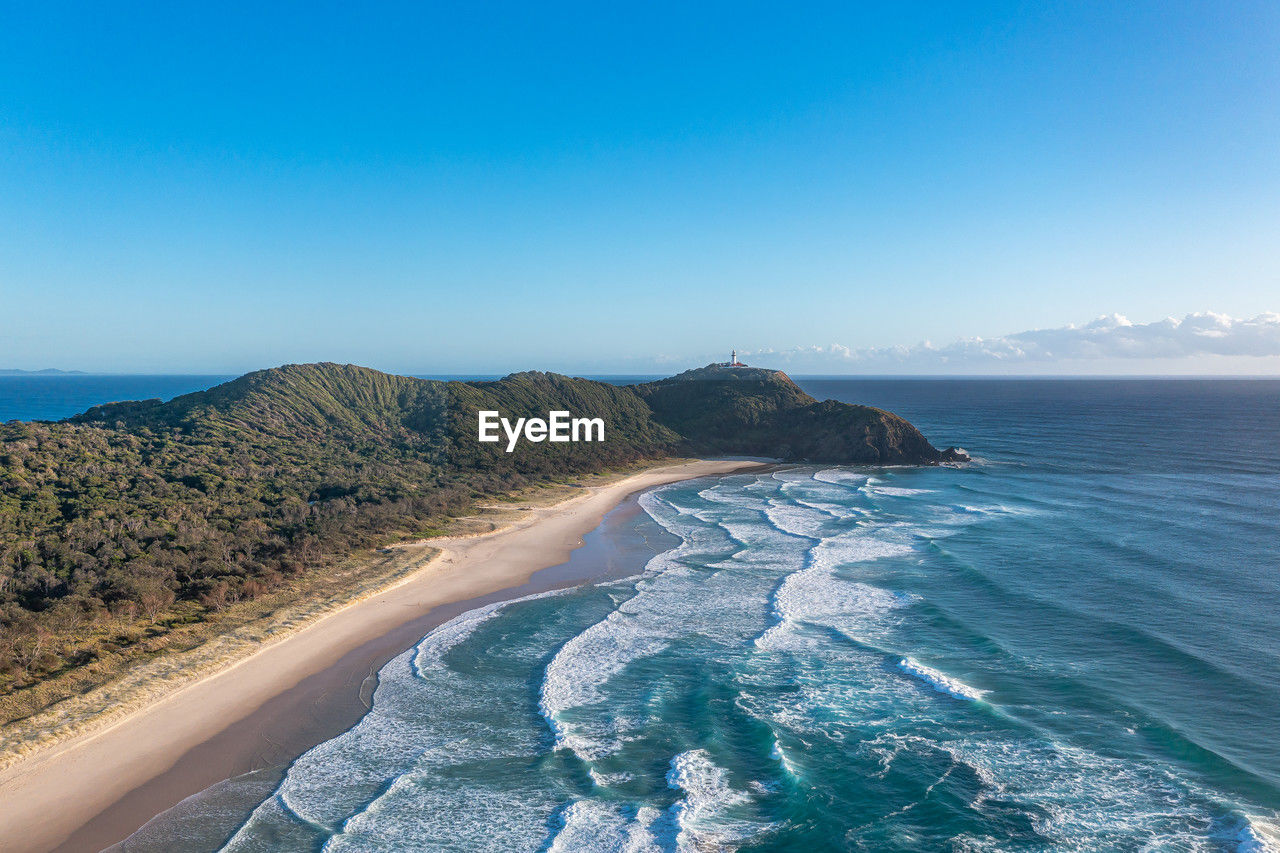Byron bay australia. scenic view ocean beach patterned waves with white foam. travel and recreation