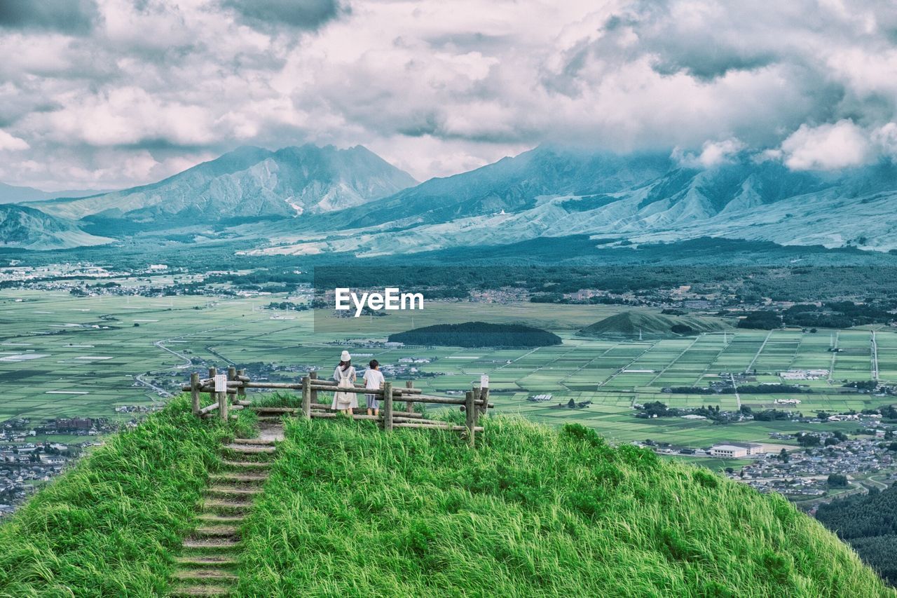 Two people overlooking countryside landscape