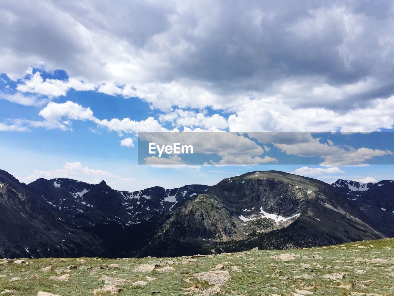 Scenic view of mountains against cloudy sky