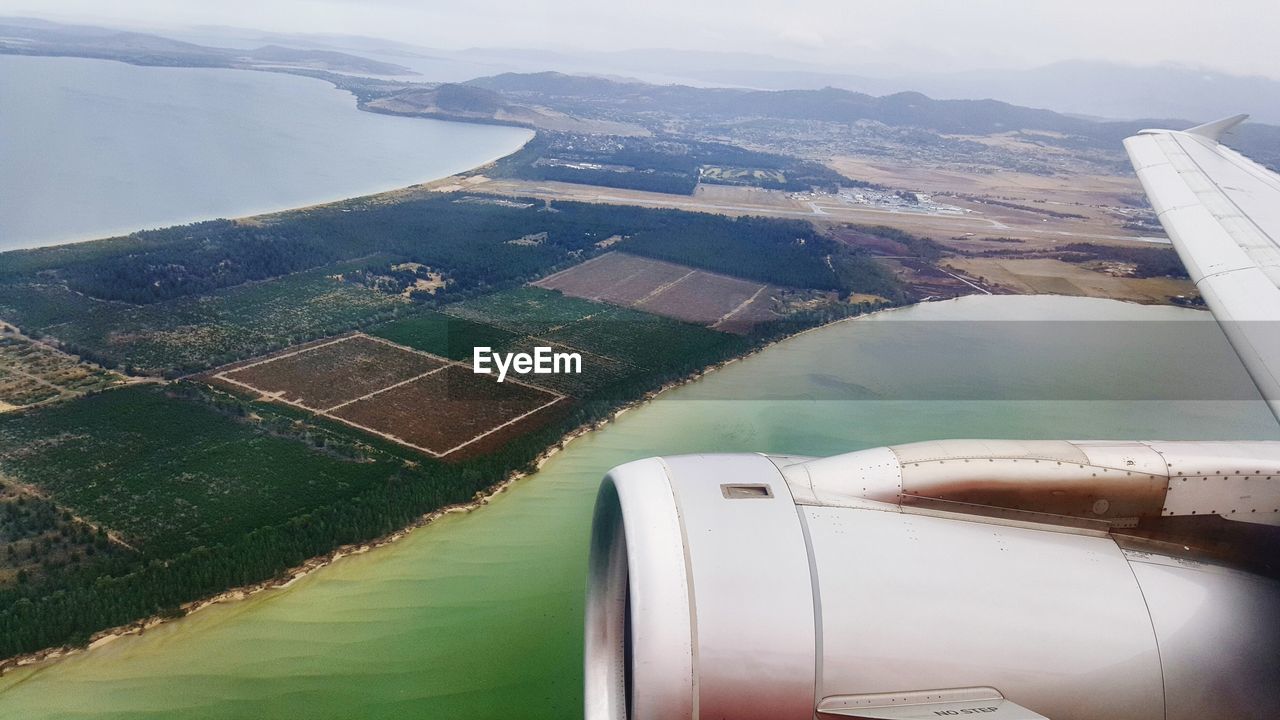 AERIAL VIEW OF RIVER AMIDST AGRICULTURAL LANDSCAPE