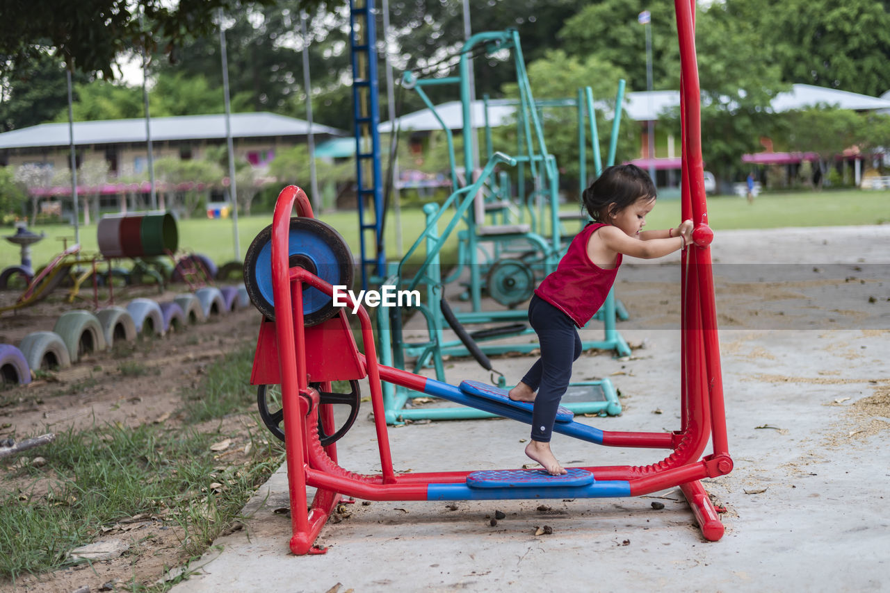 rear view of woman sitting on swing