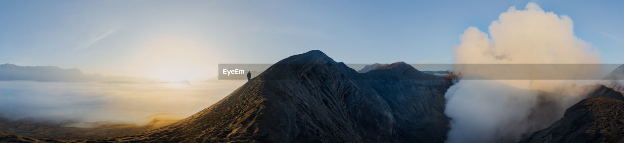 Panoramic view of man standing on mountain