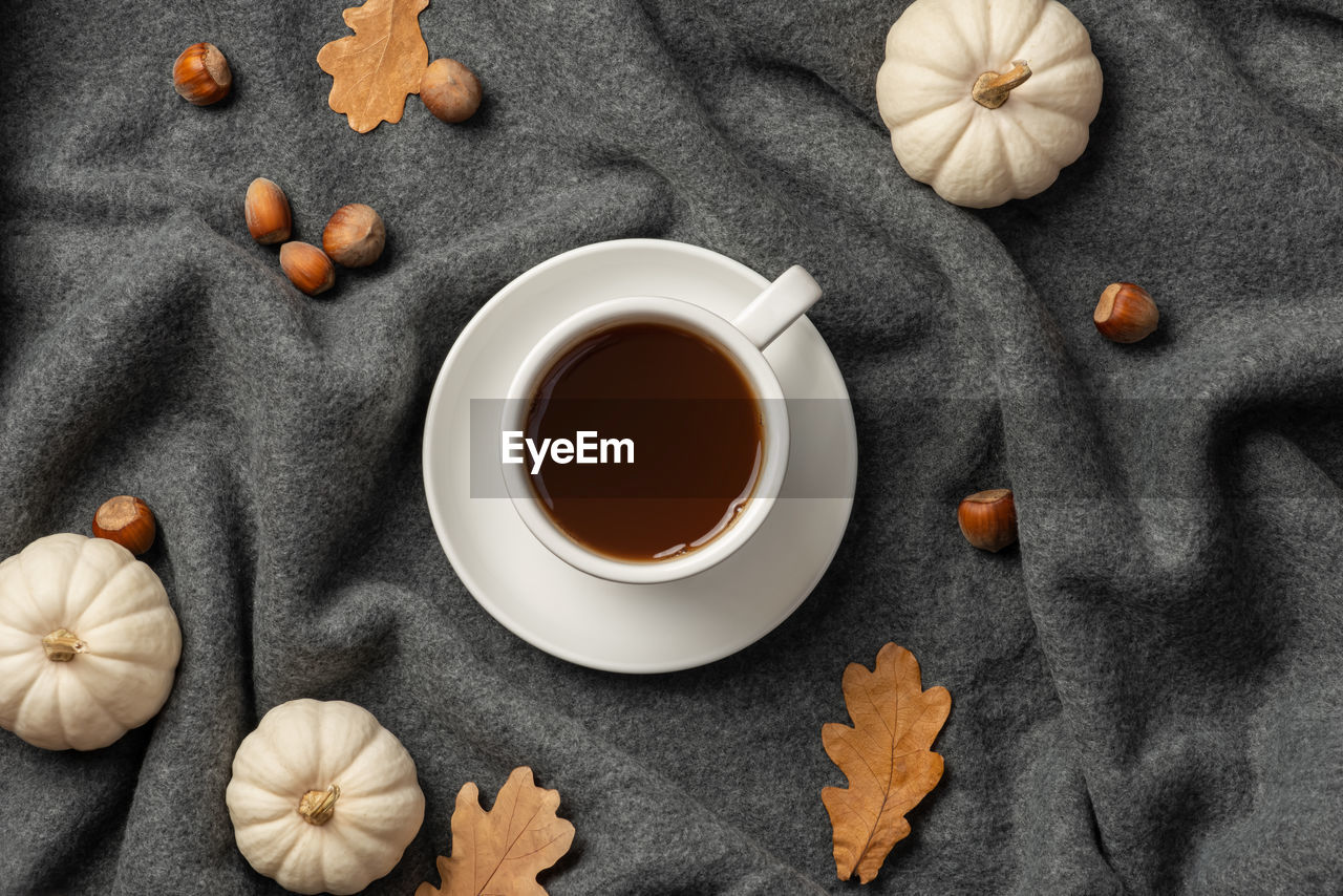 Autumn background with plaid, leaves and coffee