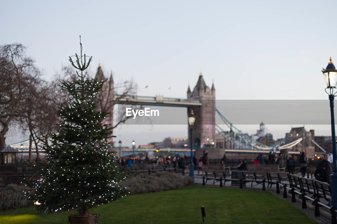 Christmas tree against tower bridge against sky