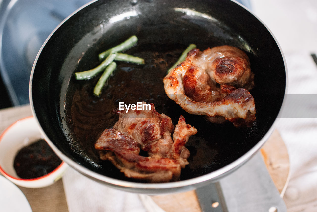 High angle view of meat in cooking pan