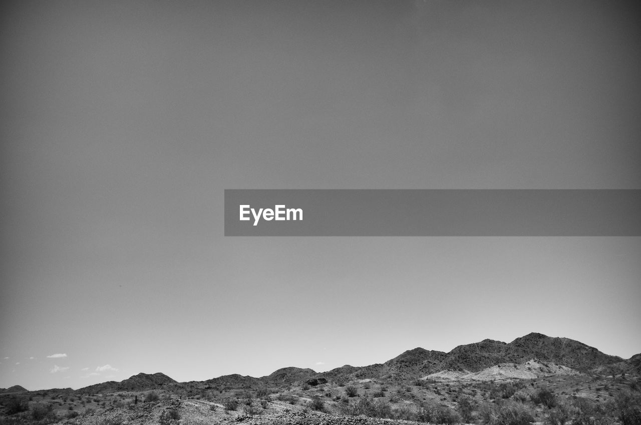 Countryside landscape against clear sky