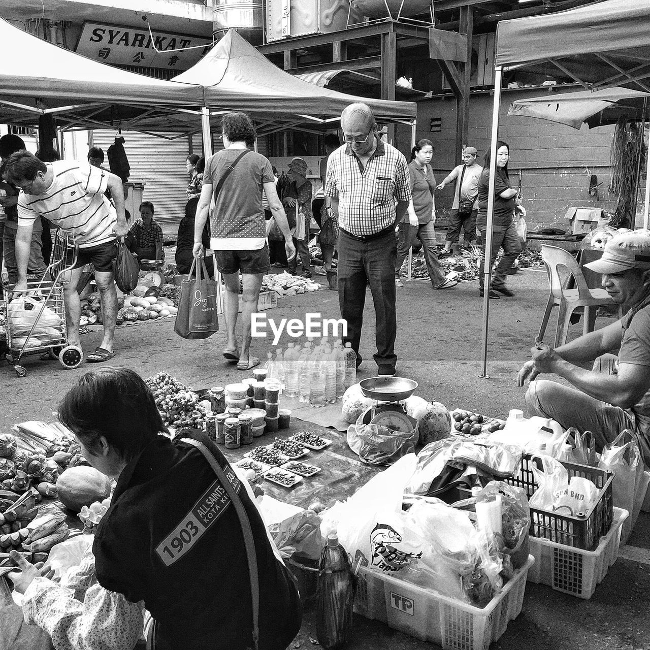 PEOPLE ON MARKET STALL