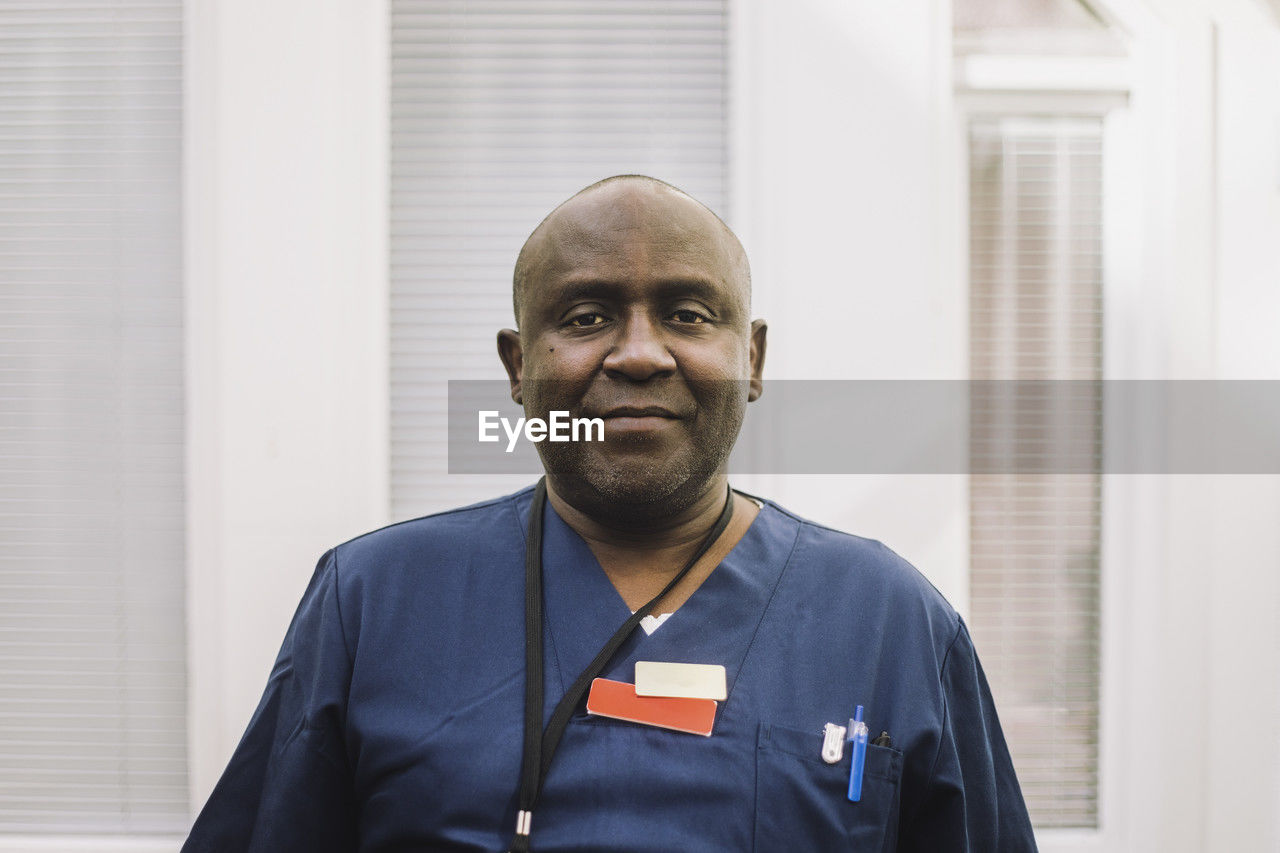 Portrait of mature male doctor with shaved head at hospital