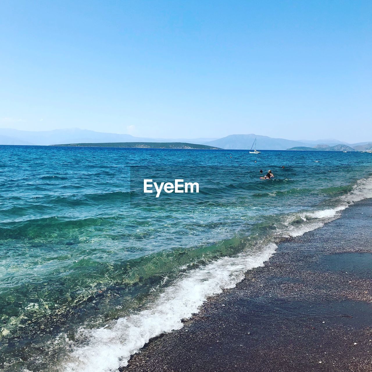 Scenic view of sea against clear blue sky