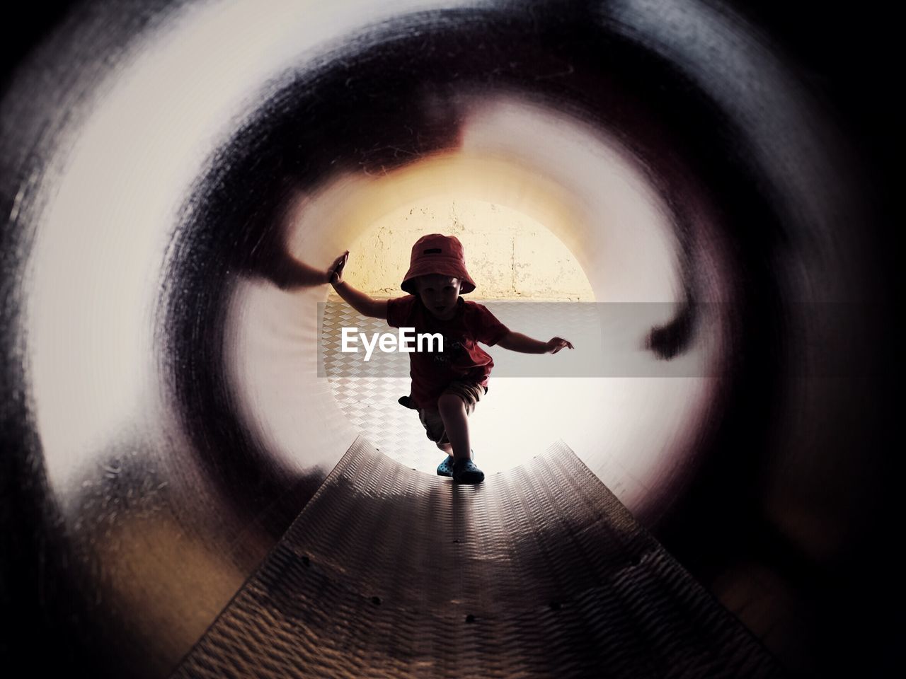 High angle view of boy standing in covered slide