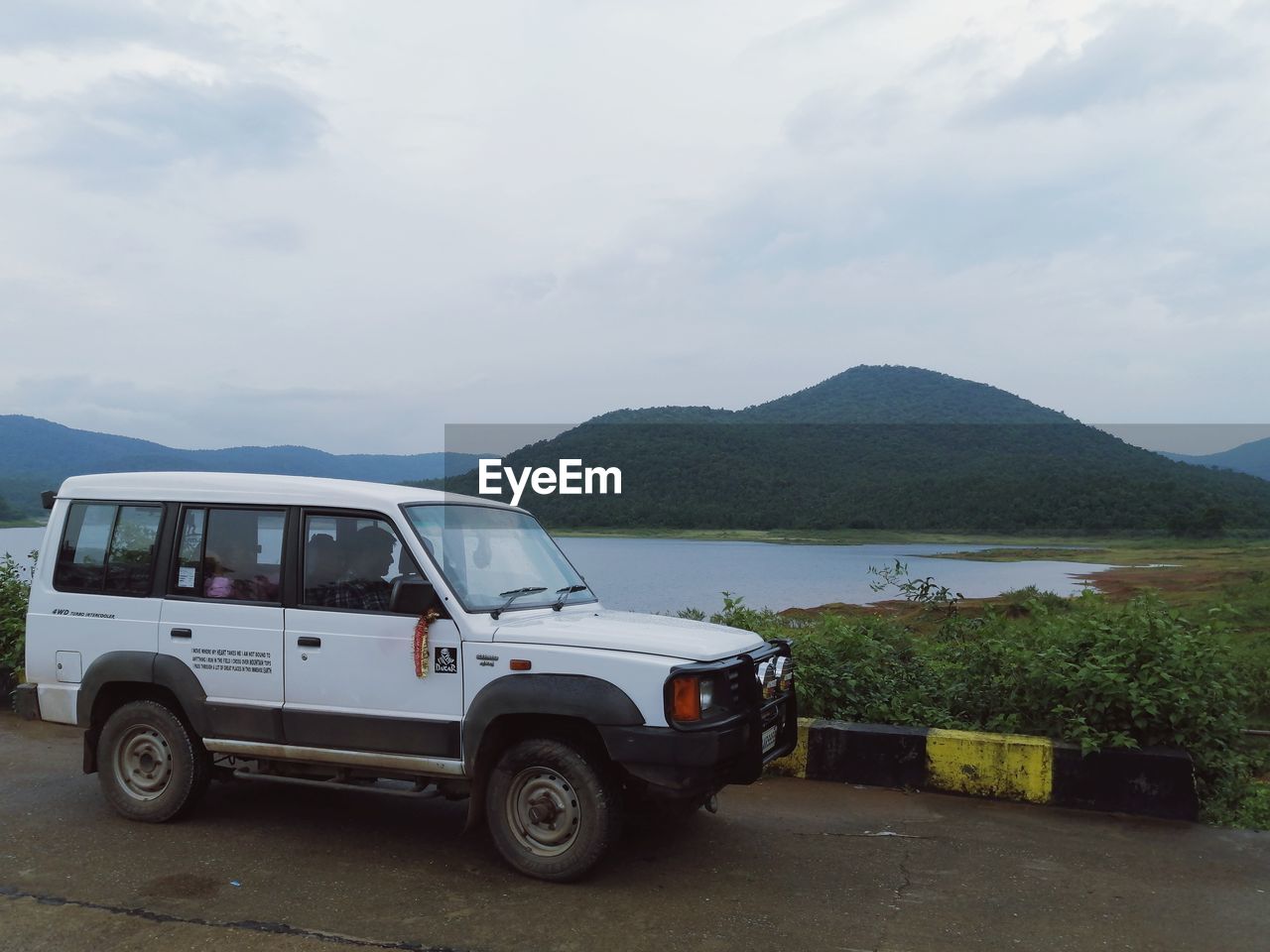 VEHICLES ON ROAD AGAINST SKY