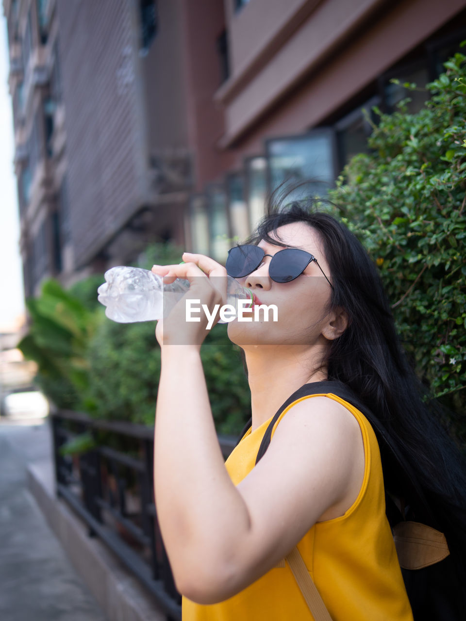 Young woman drinking water from bottle