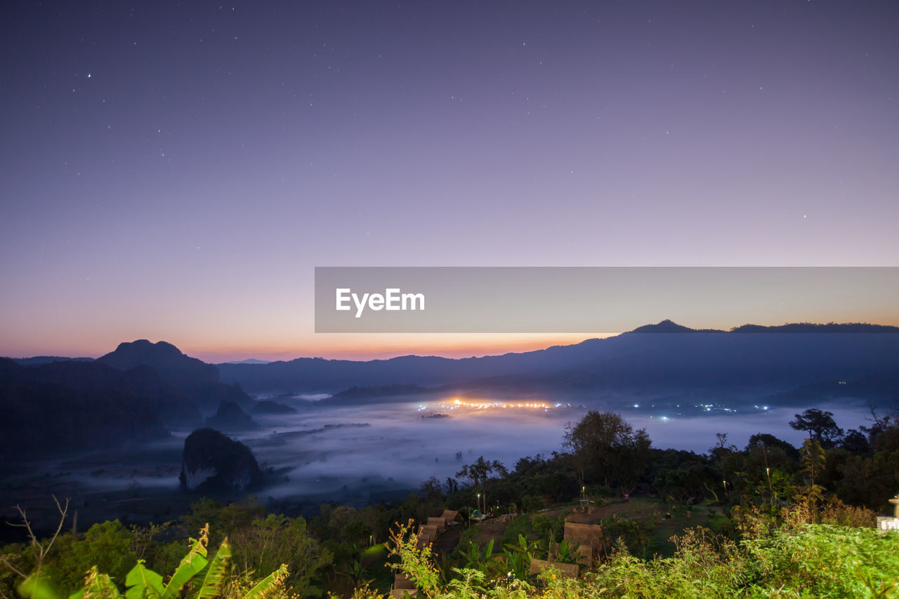 SCENIC VIEW OF MOUNTAINS AGAINST SKY AT SUNSET