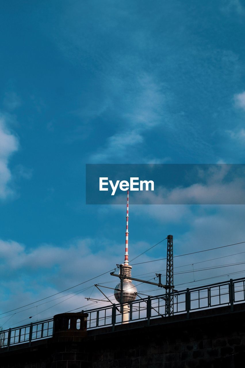 Low angle view of communications tower against sky