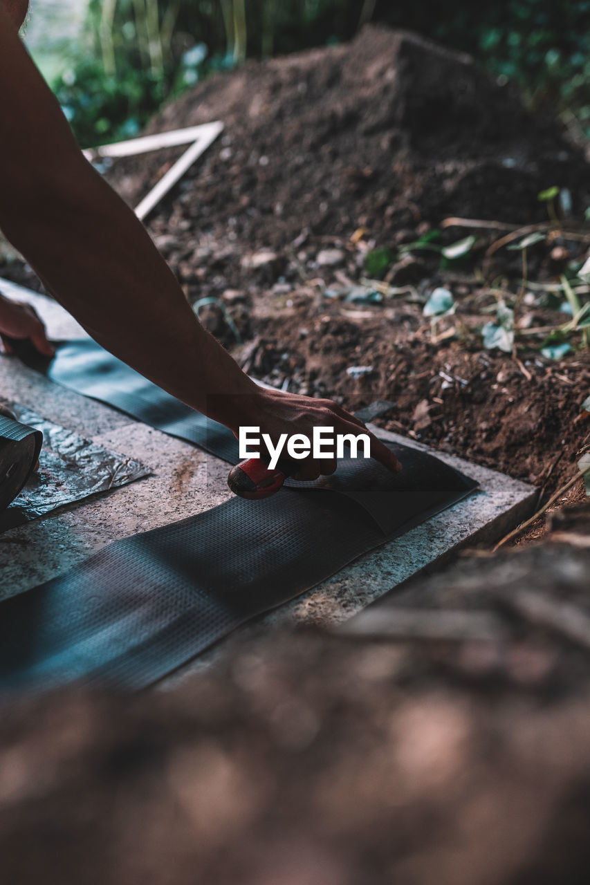 Worker working with tool in ground