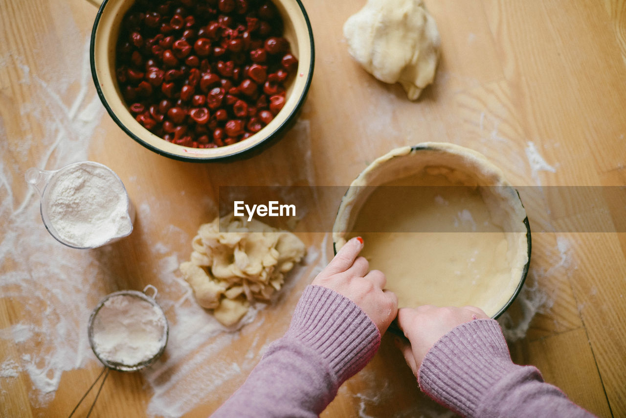 Cropped hands of woman preparing food in kitchen