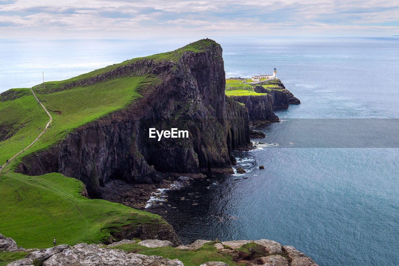 scenic view of sea and mountains against sky