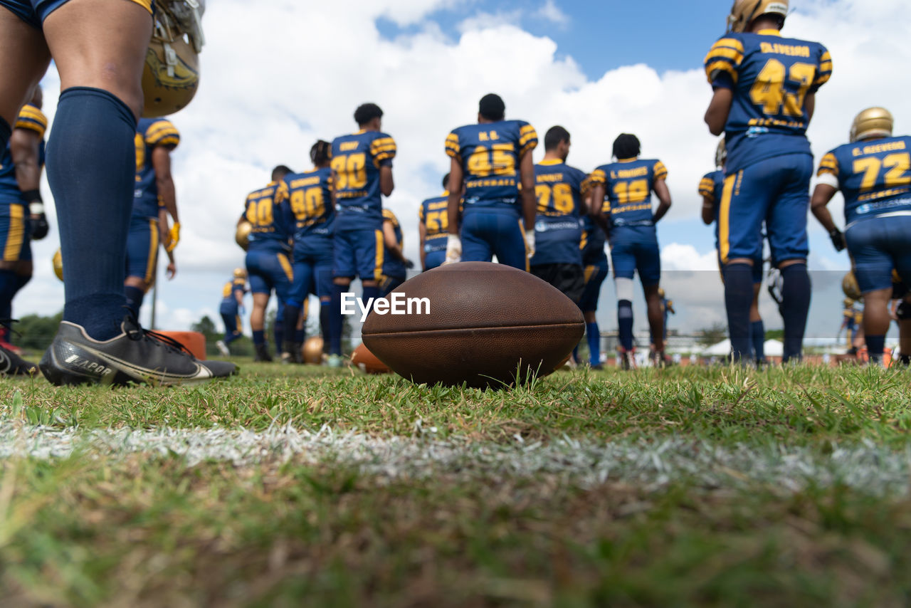 American football players are seen on the playing field at the armando oliveira stadium