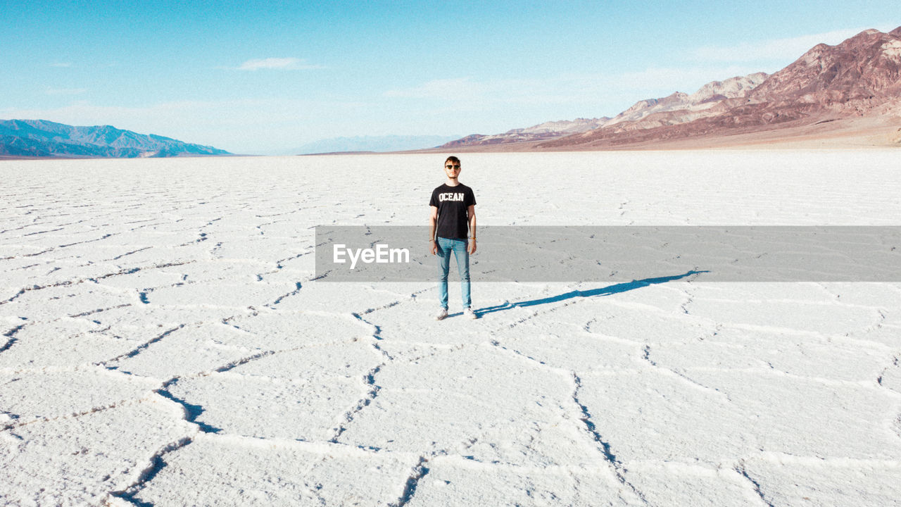 Full length of man standing on arid landscape