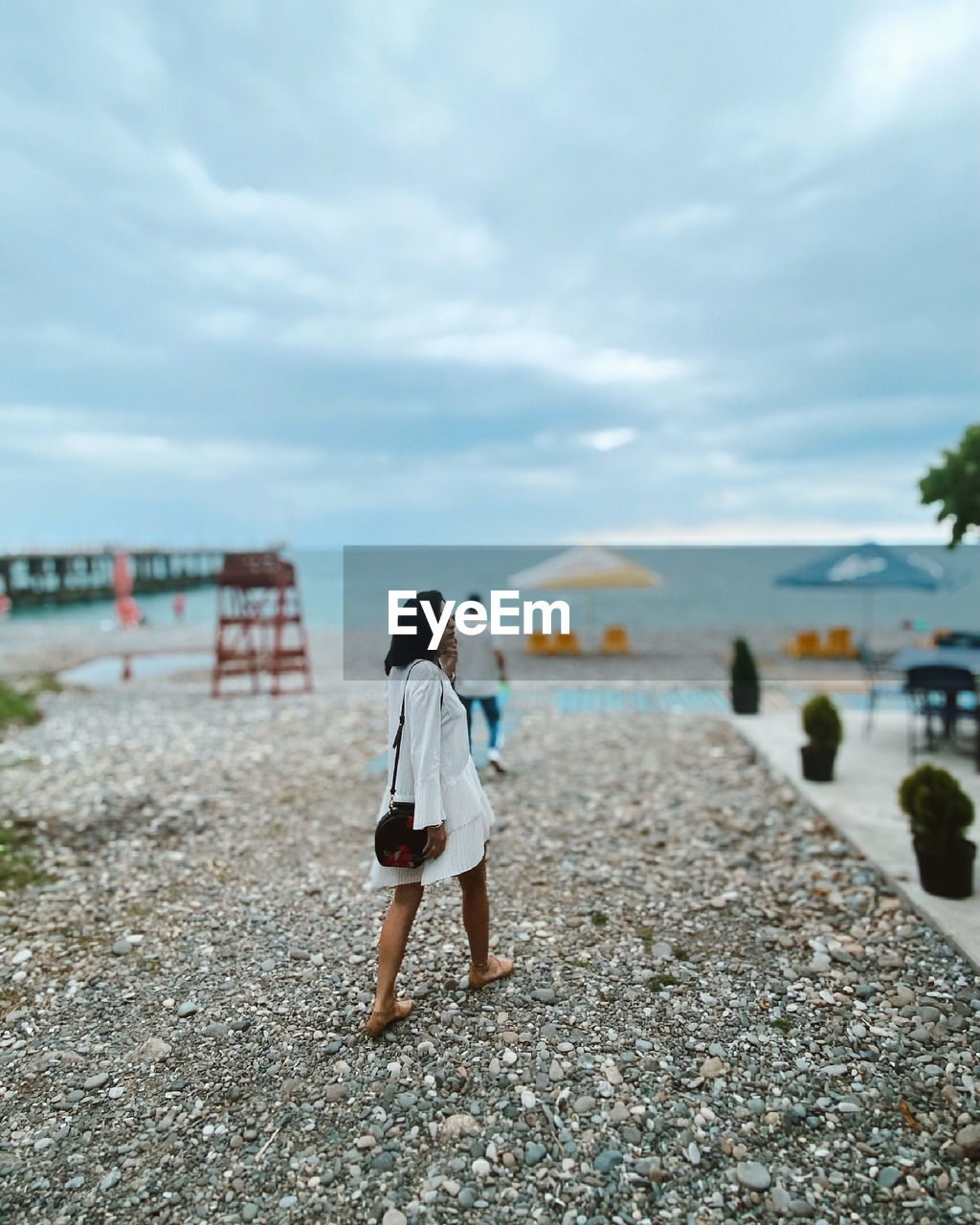 Rear view of woman walking on beach