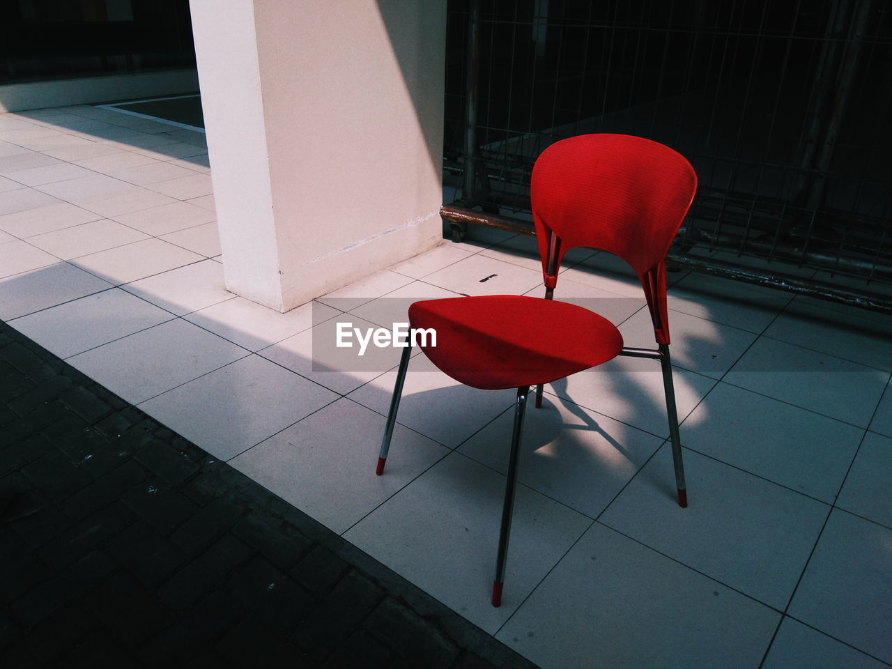 Red empty chair on floor