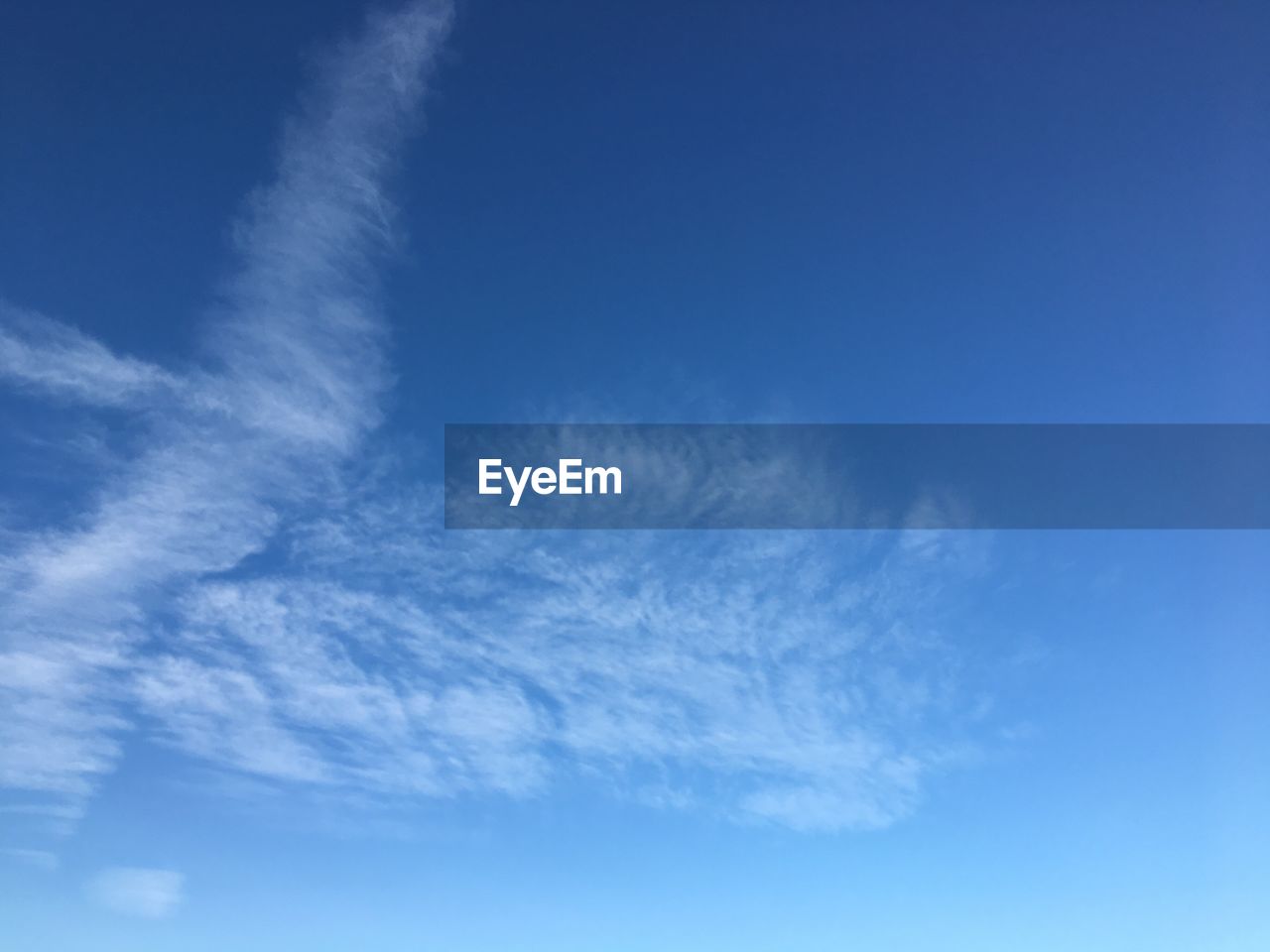 LOW ANGLE VIEW OF VAPOR TRAILS AGAINST SKY