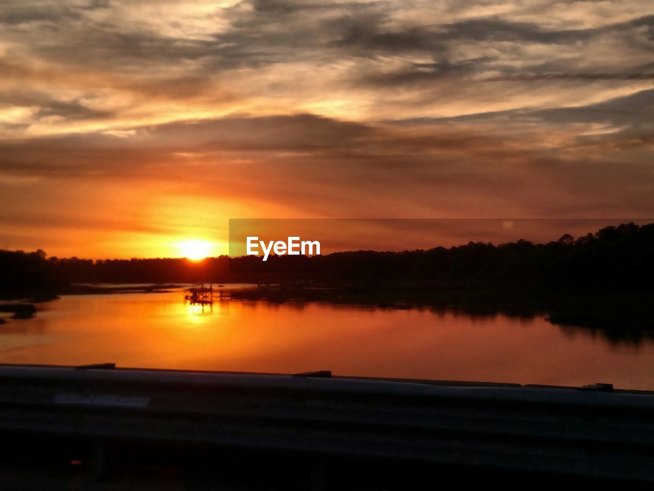 Sun setting over lake