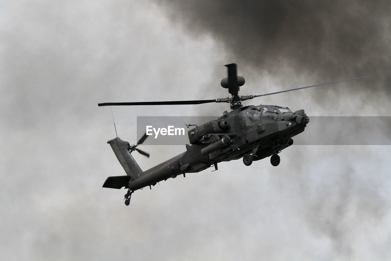 Low angle view of apache helicopter in flying in sky