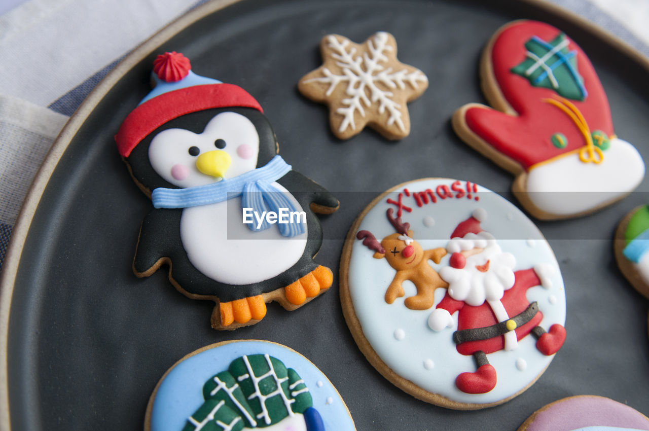 Multi colored gingerbread cookies during christmas in plate