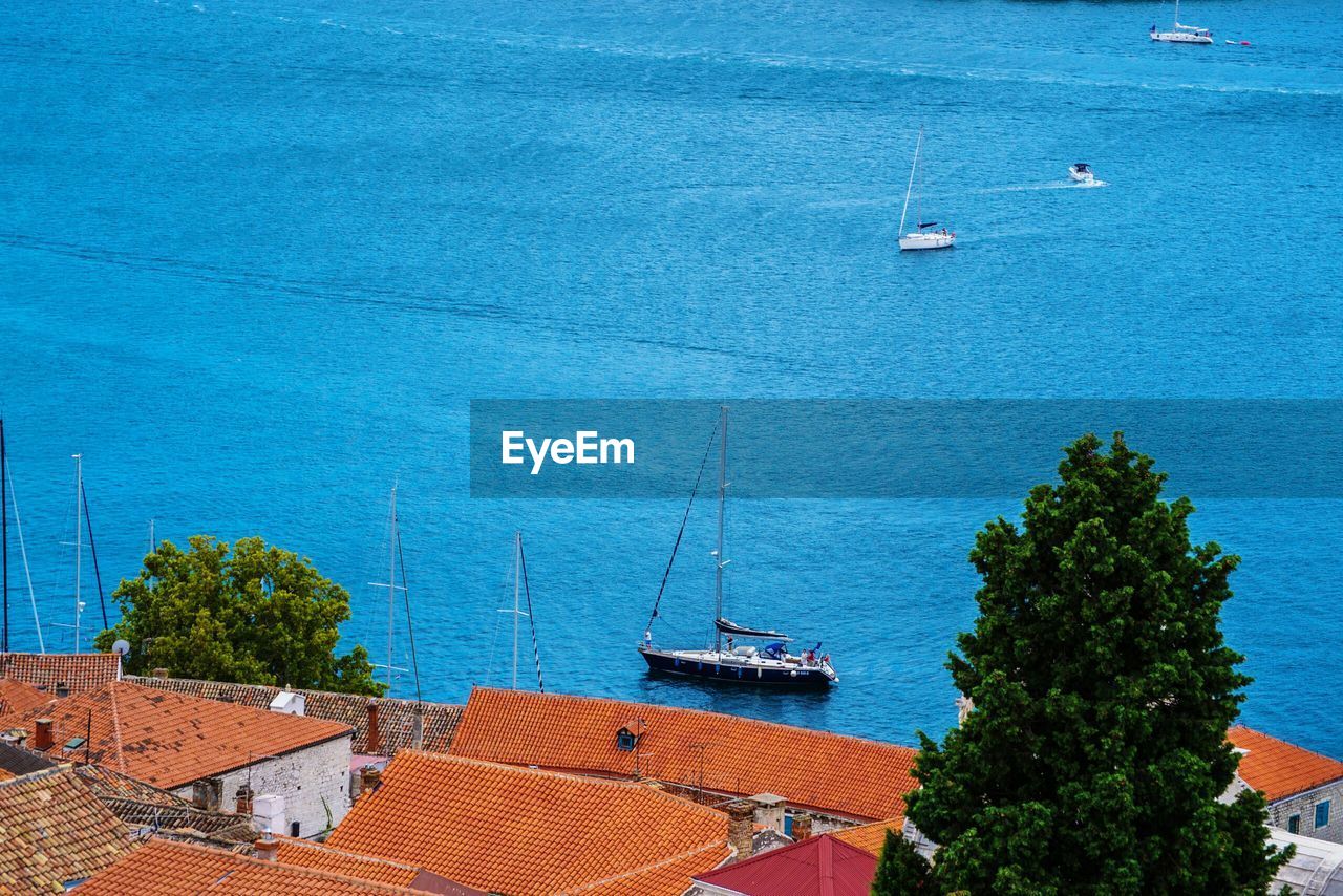 High angle view of sailboats moored on sea against sky