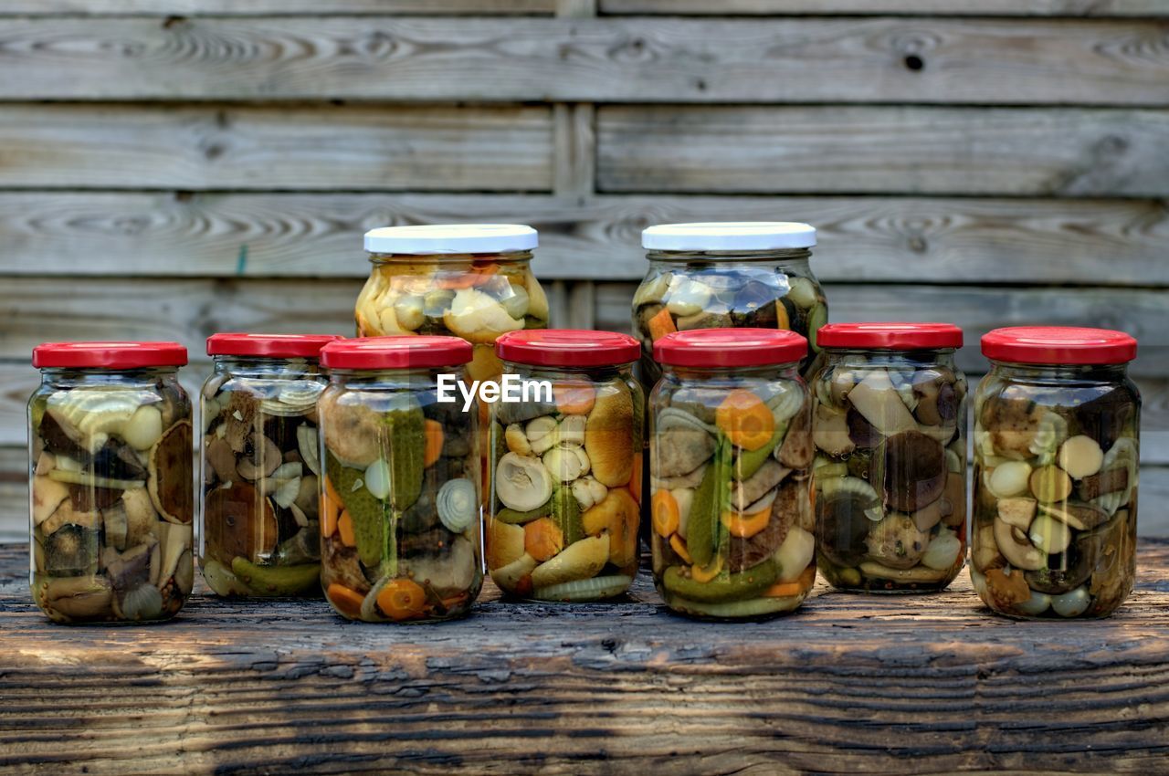 VARIOUS FRUITS IN JAR ON TABLE AT HOME