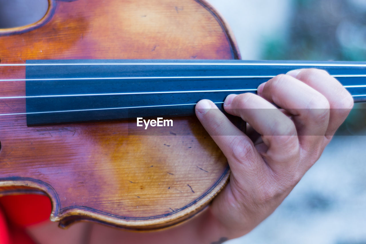 Cropped hand playing violin