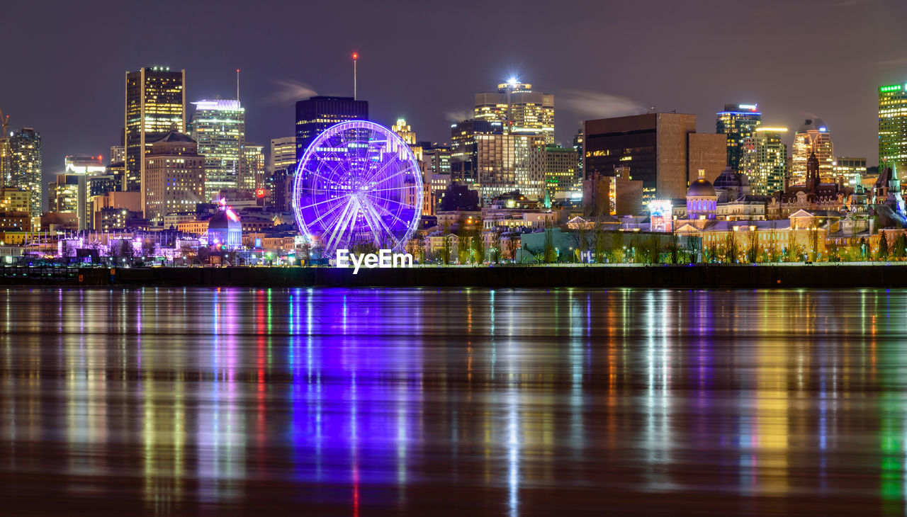 ILLUMINATED BUILDINGS IN CITY AT NIGHT