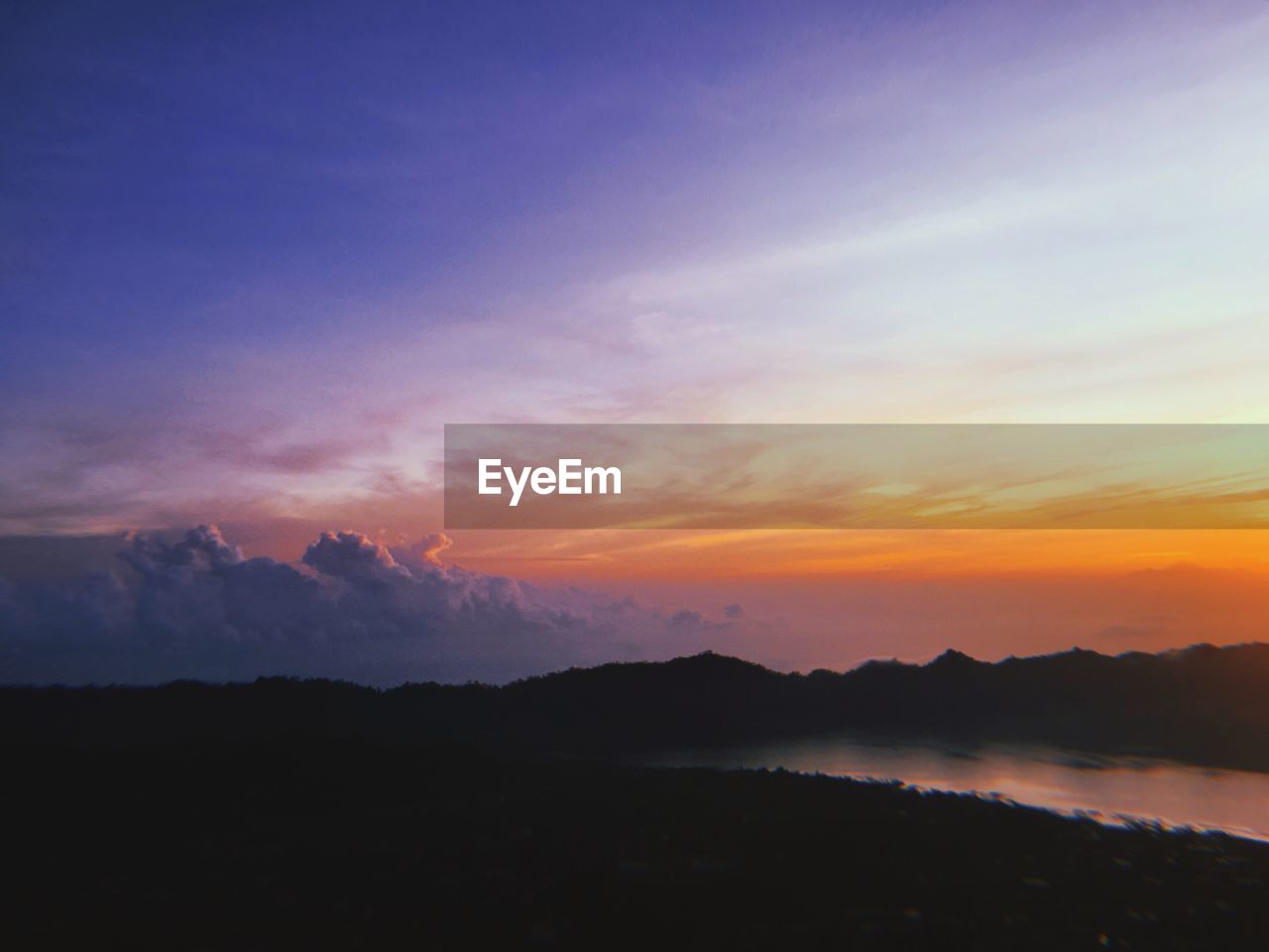 Scenic view of silhouette mountains against sky at sunset