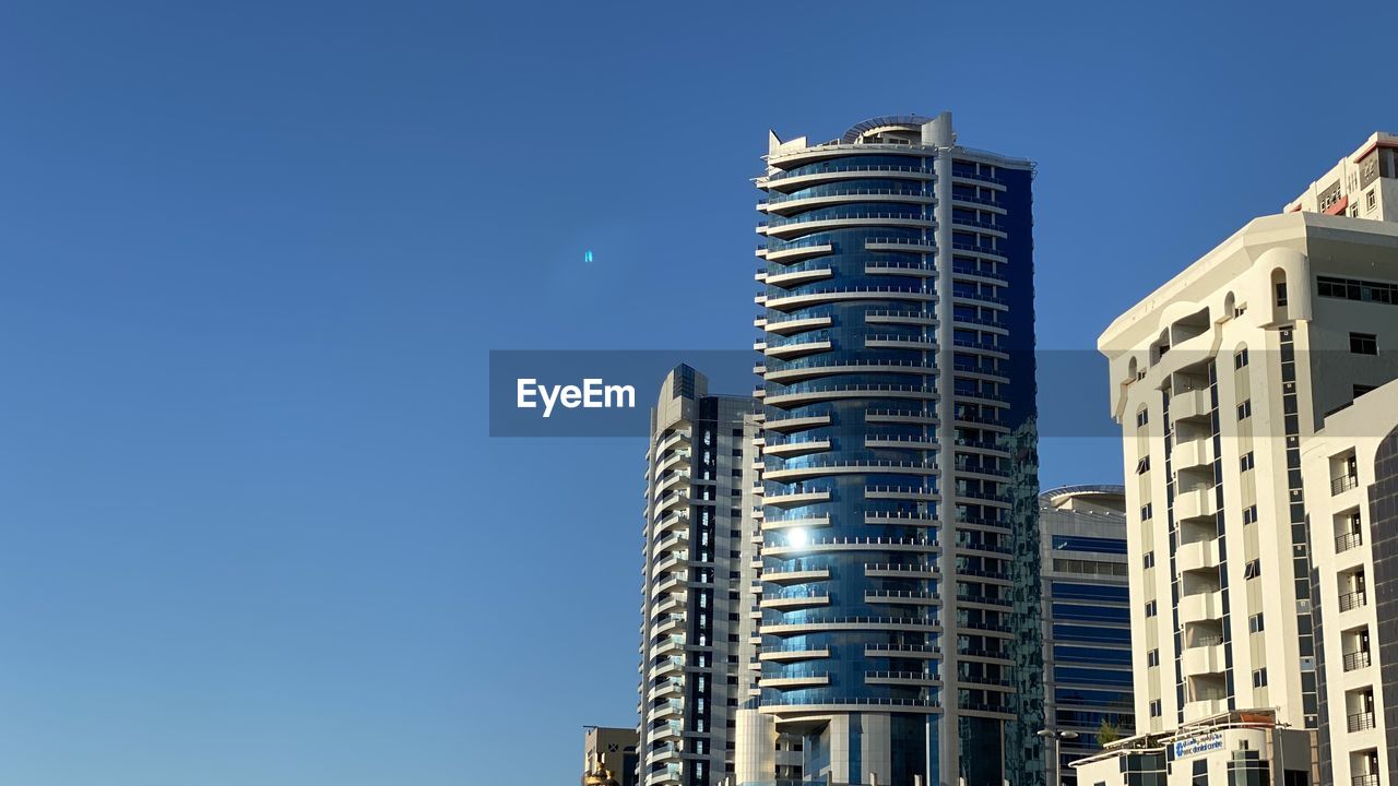 Modern dubai buildings view against clear blue sky