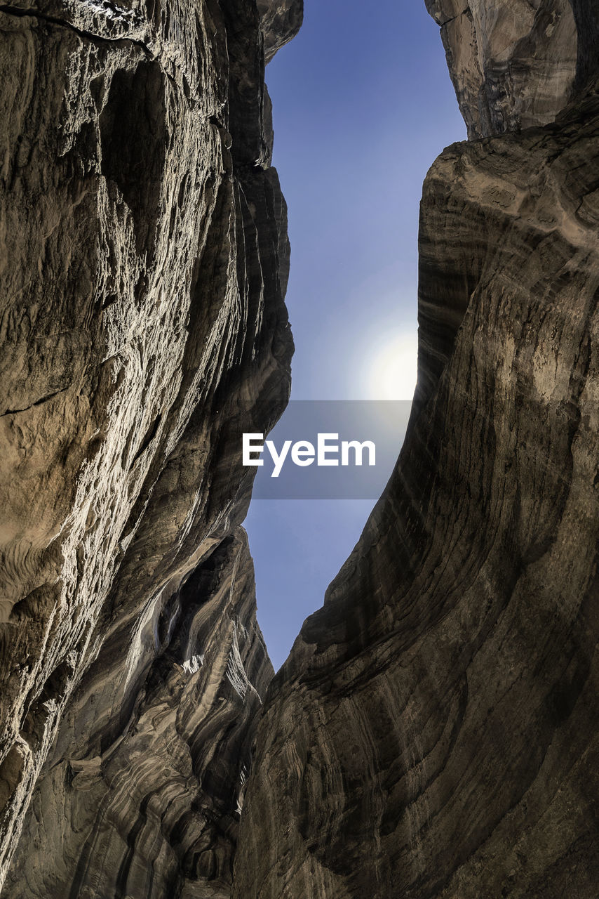 LOW ANGLE VIEW OF ROCK FORMATIONS AGAINST SKY