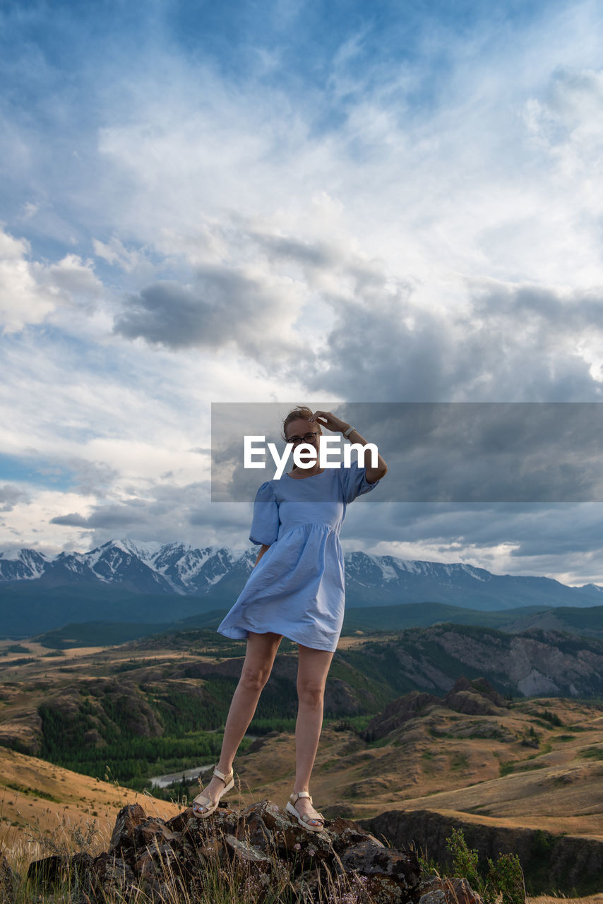 rear view of woman standing on mountain