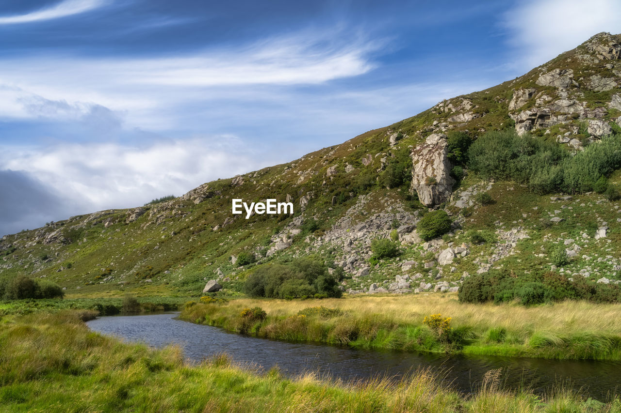 Winding river at a foothill of rocky mountain. lough dan, wicklow mountains, ireland