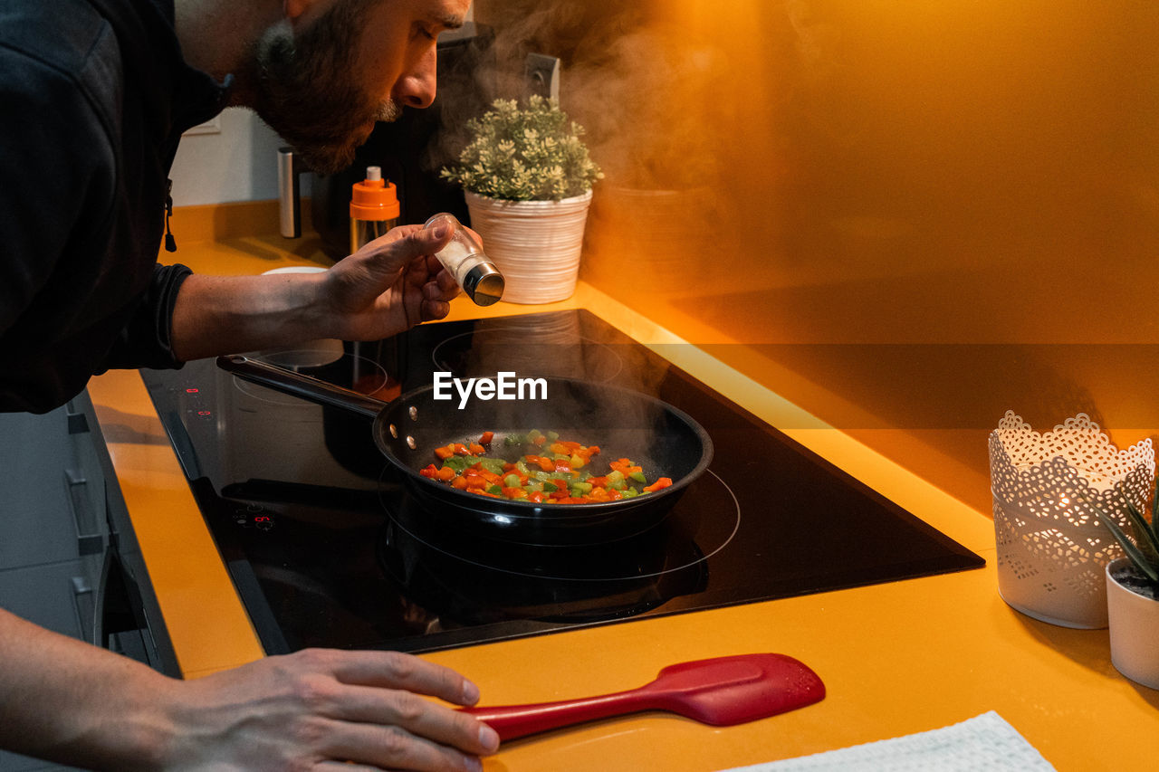 midsection of man preparing food on table