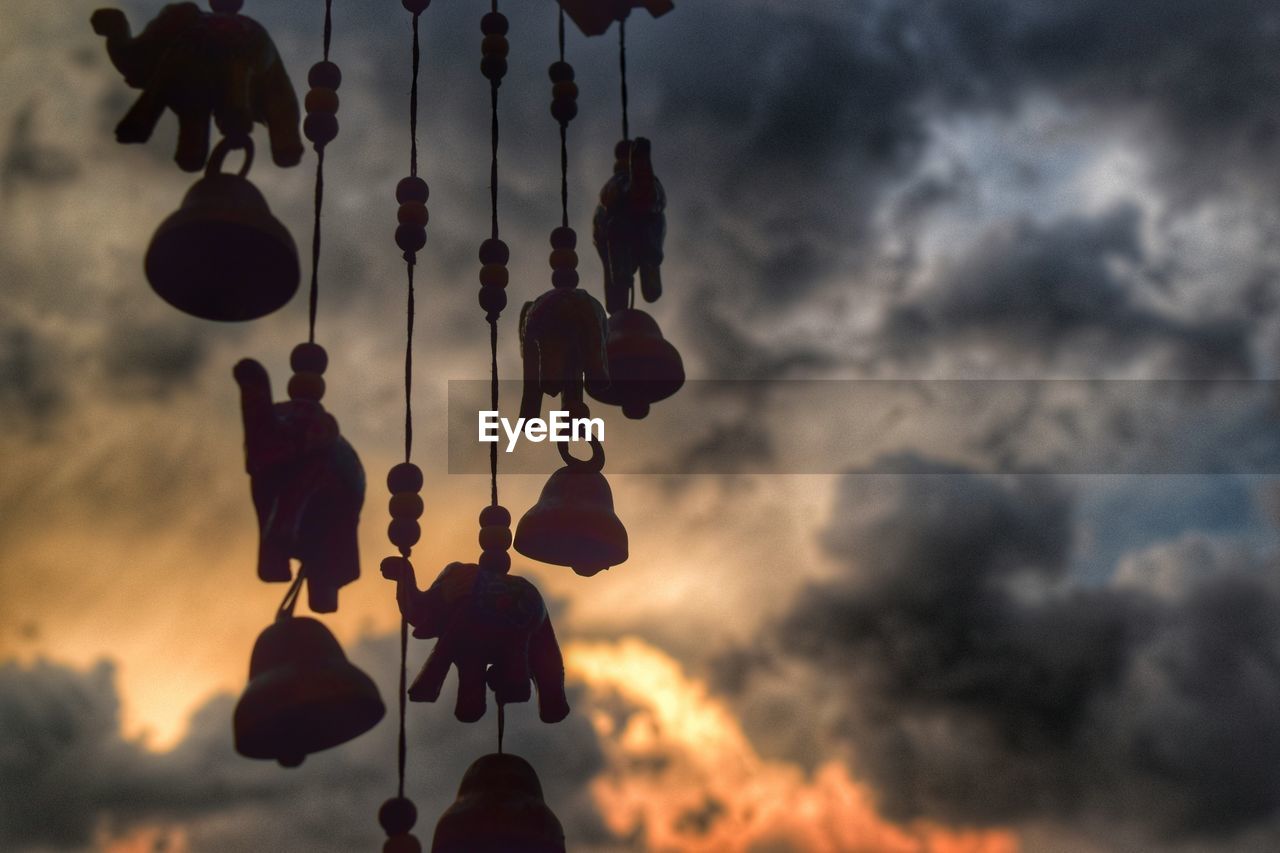 Low angle view of silhouette decoration against cloudy sky