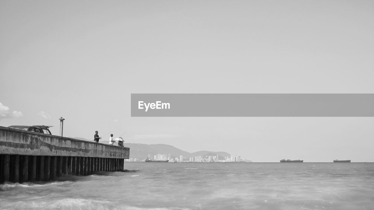 BUILT STRUCTURE ON SEA AGAINST CLEAR SKY