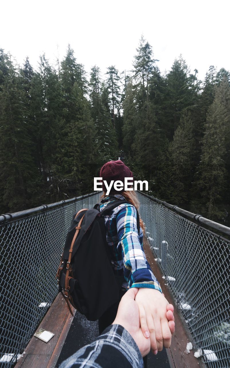 Personal perspective of couple on footbridge