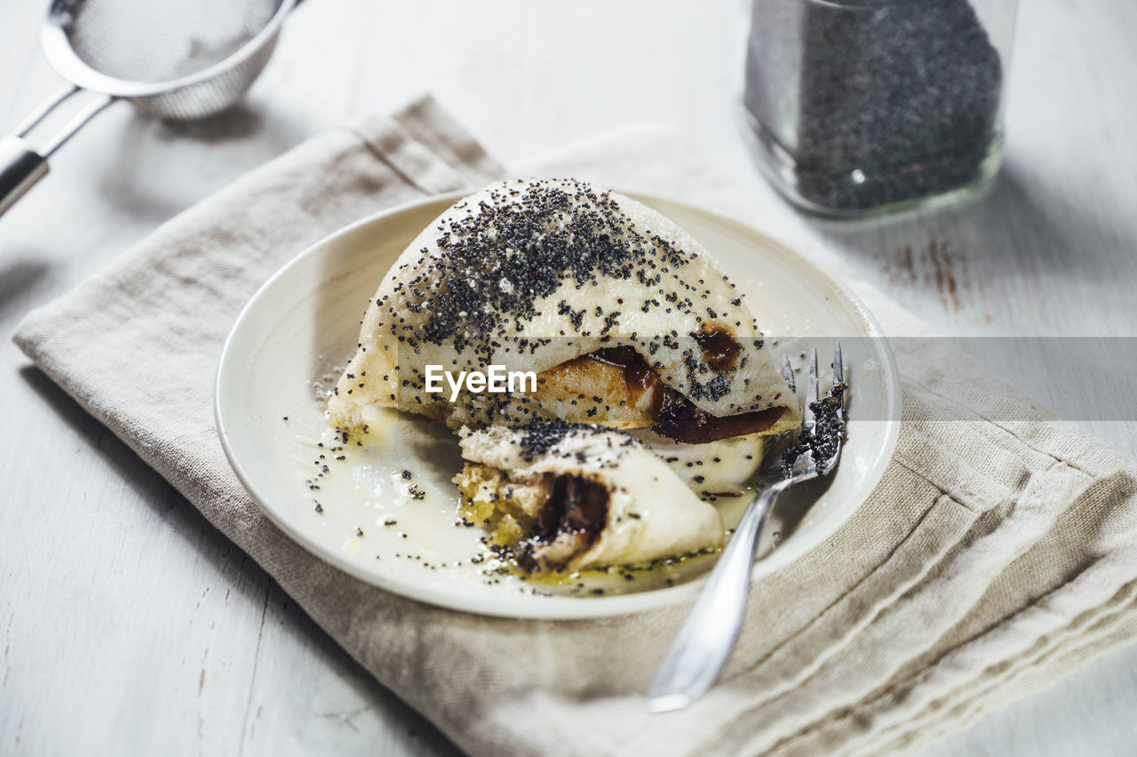 Sweet germknodel dumpling with poppy seeds and plum jam