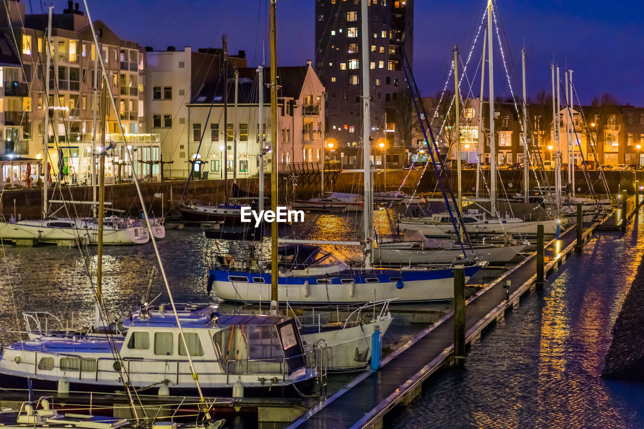 BOATS MOORED IN HARBOR