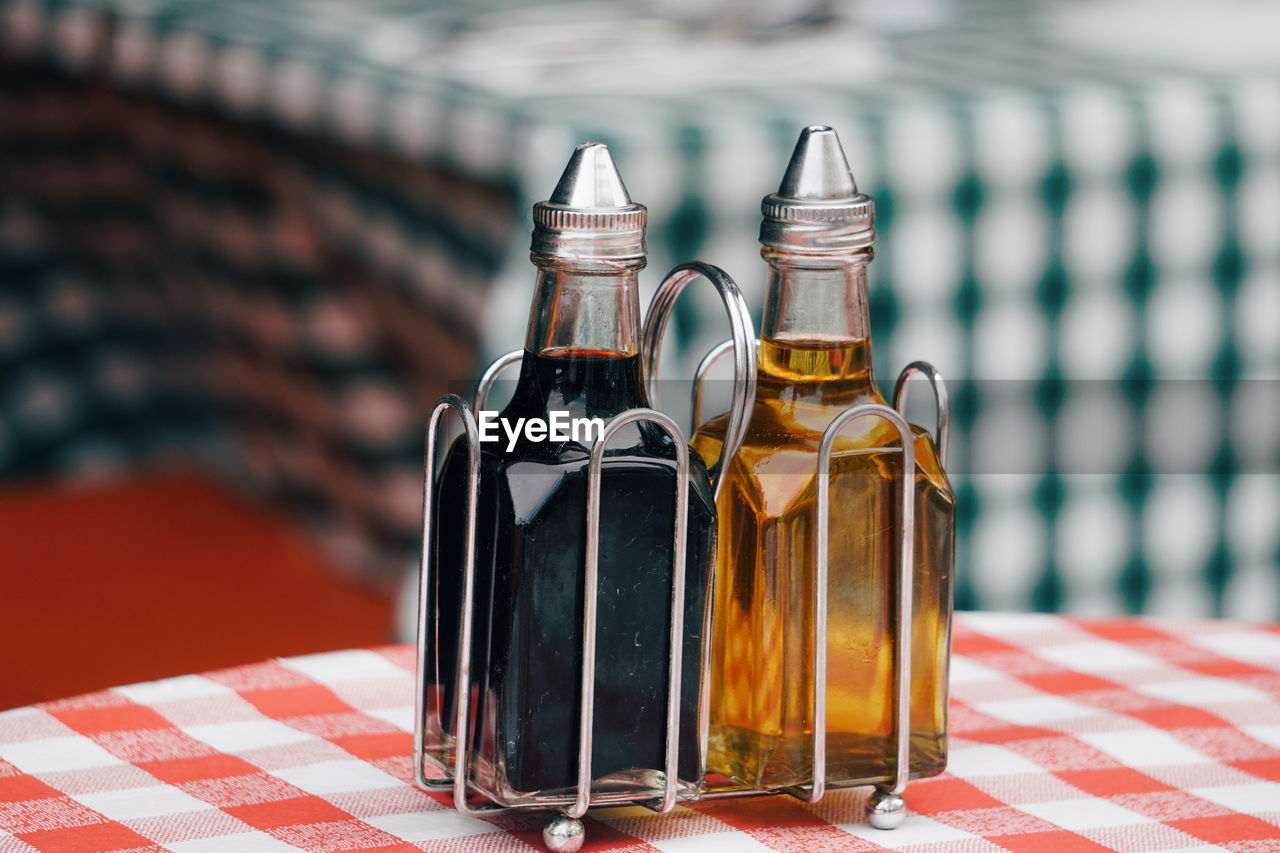 Close-up of olive oil and vinegar on table