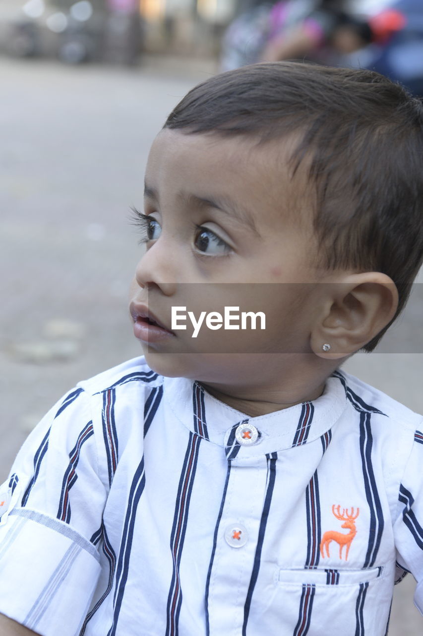 Portrait of cute boy looking away