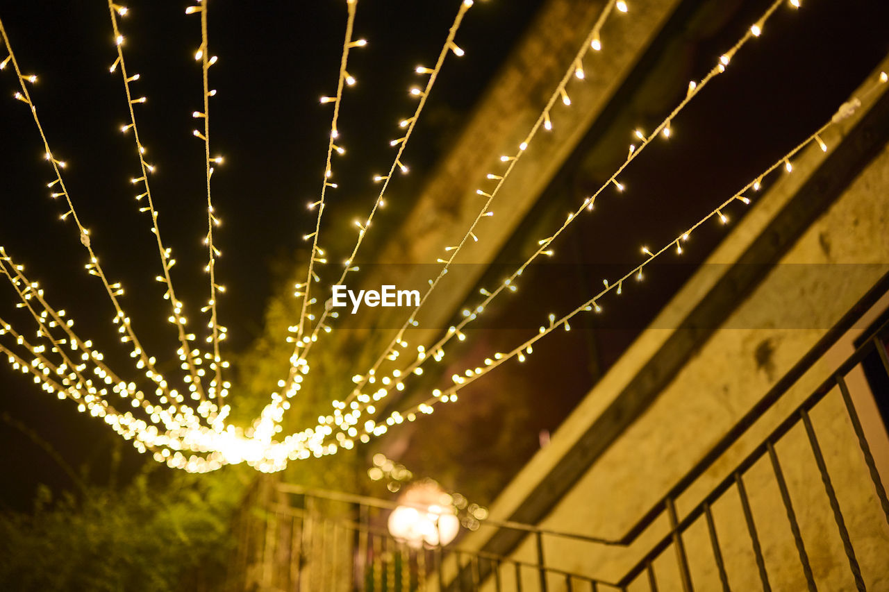 LOW ANGLE VIEW OF ILLUMINATED LIGHTS IN CEILING