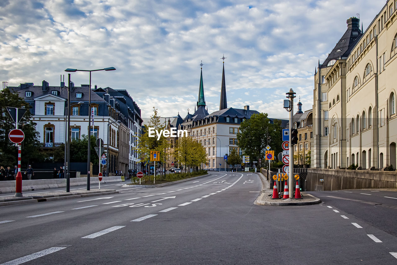 City street and buildings against sky